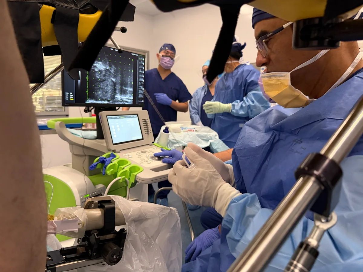 Dr Raji Kooner and his theatre team performing one of the first ExactVu prostate micro-ultrasound cases in Australia, with the micro-ultrasound image on screen, July 2026