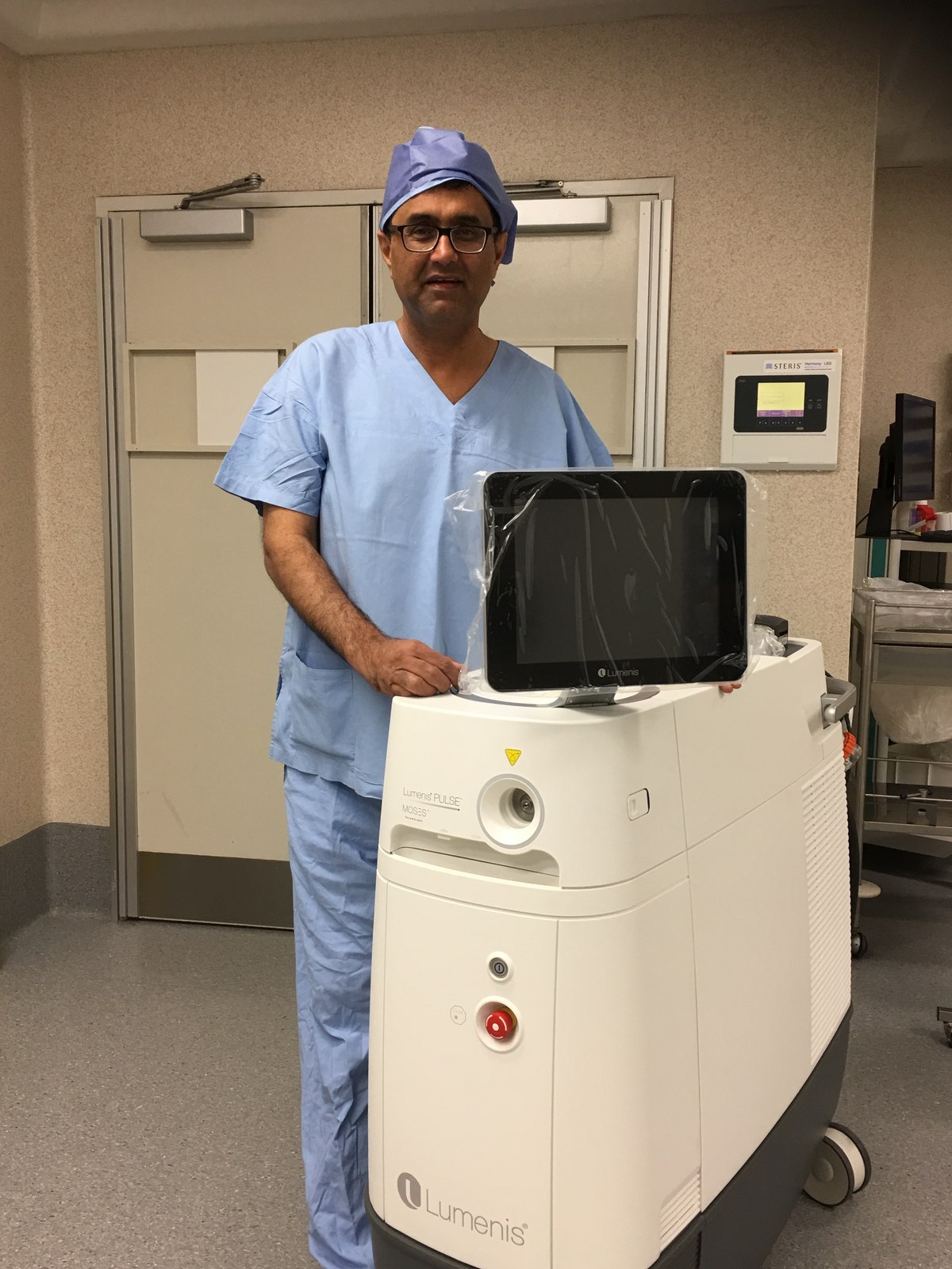 Dr Raji Kooner beside a Lumenis holmium laser system in theatre