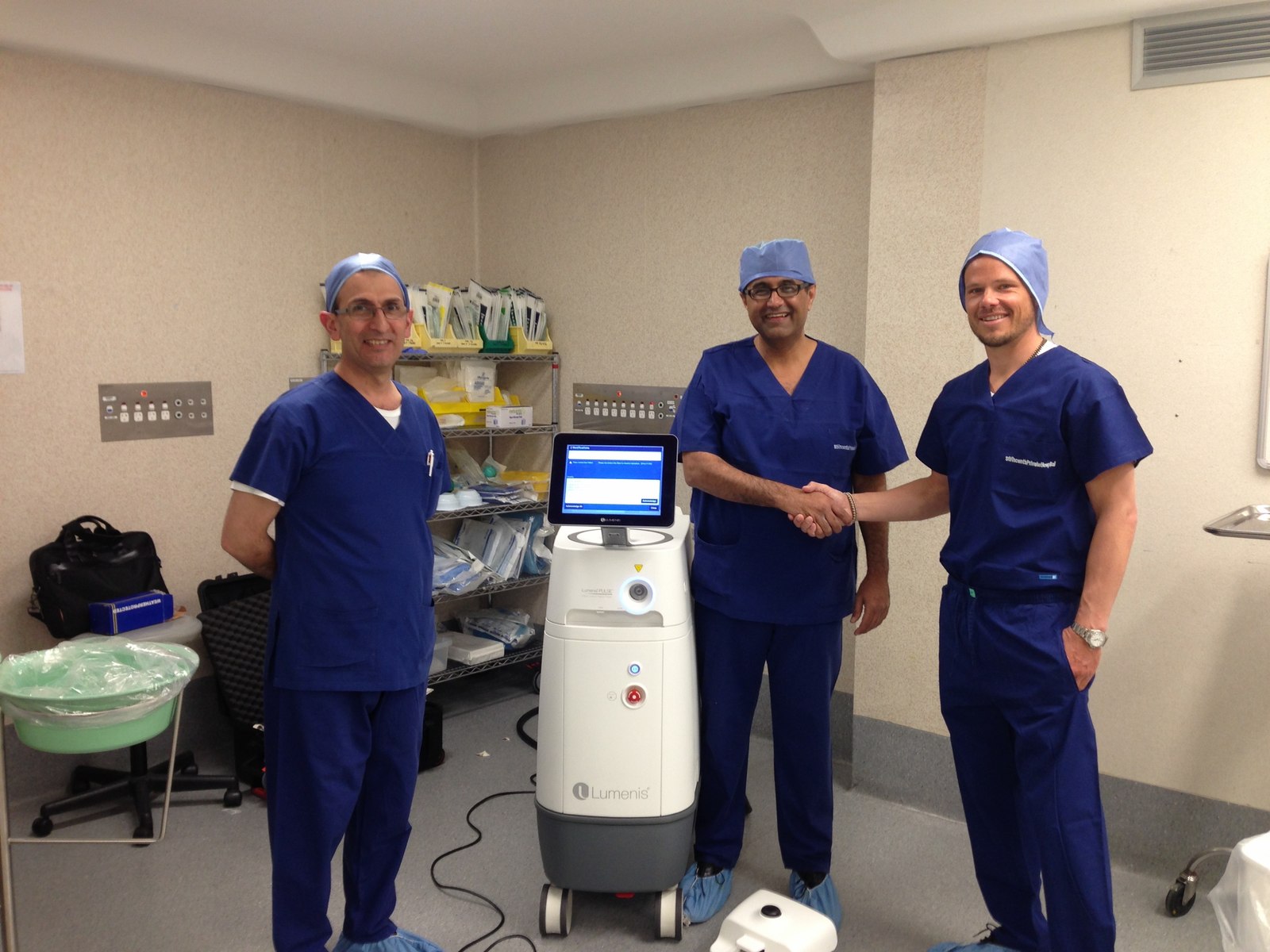 Dr Raji Kooner and colleagues beside a Lumenis holmium laser platform in theatre